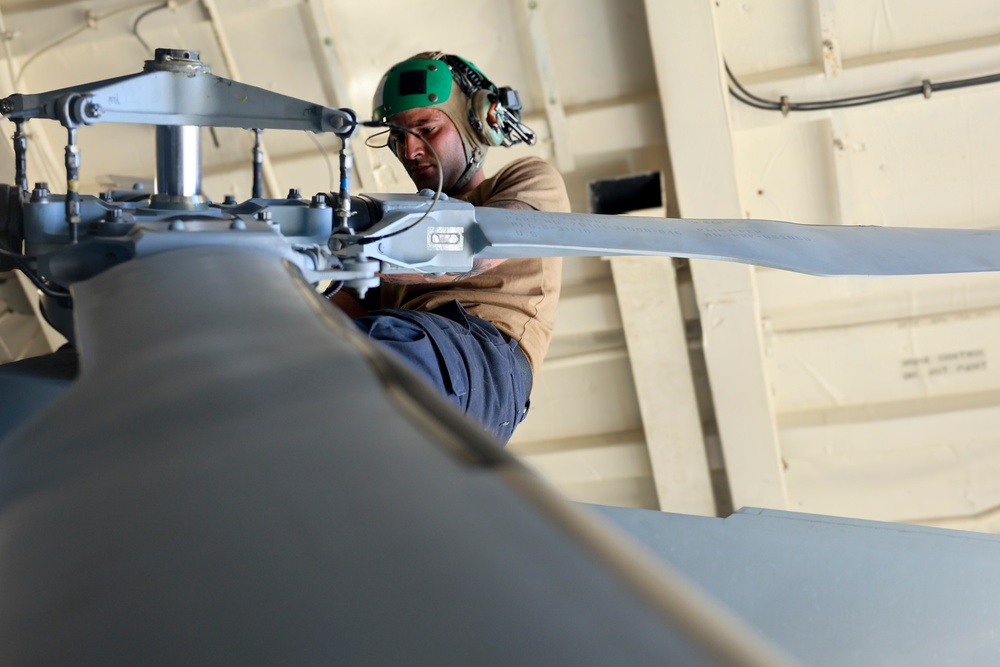 U.S. Navy Sailor preforms preventative aboard the USS Bulkeley