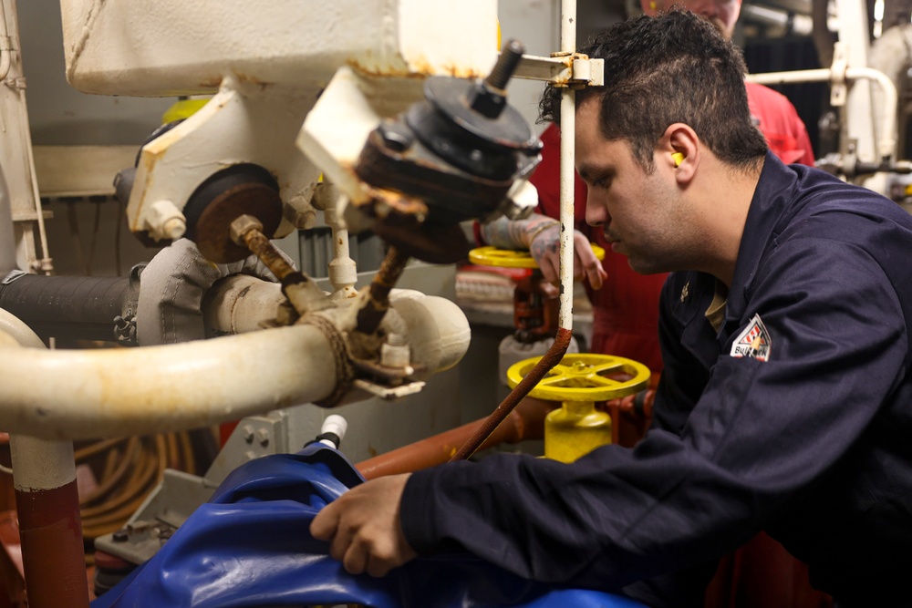 U.S. Navy Sailor responds to engineering casualties during a simulated emergency drill