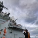 U.S. Navy Sailor conducts a fresh-water washdown aboard the USS Bulkeley