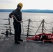 Boatswain’s Mate prepares a ladder for a visiting pilot