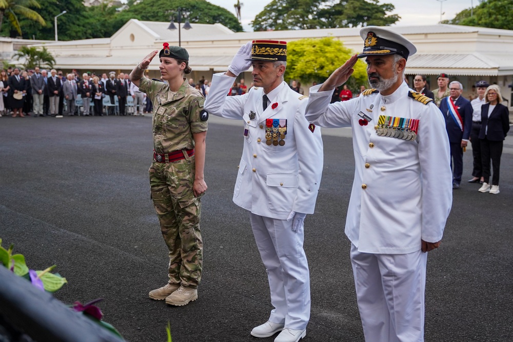 Leaders salute during Anzac Day ceremony in Nouméa