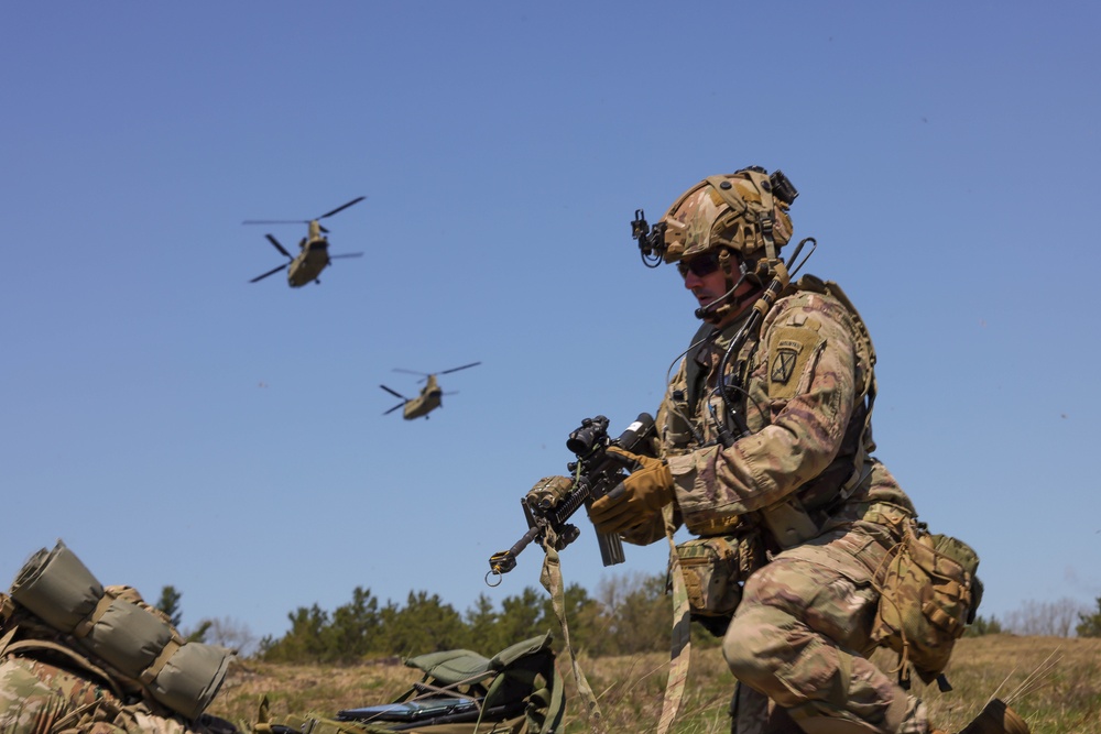 A Soldier adjusts his rifle