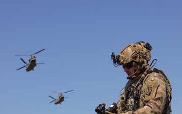 A Soldier adjusts his rifle