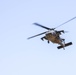 A Crewmember waves out of a UH-60 BlackHawk