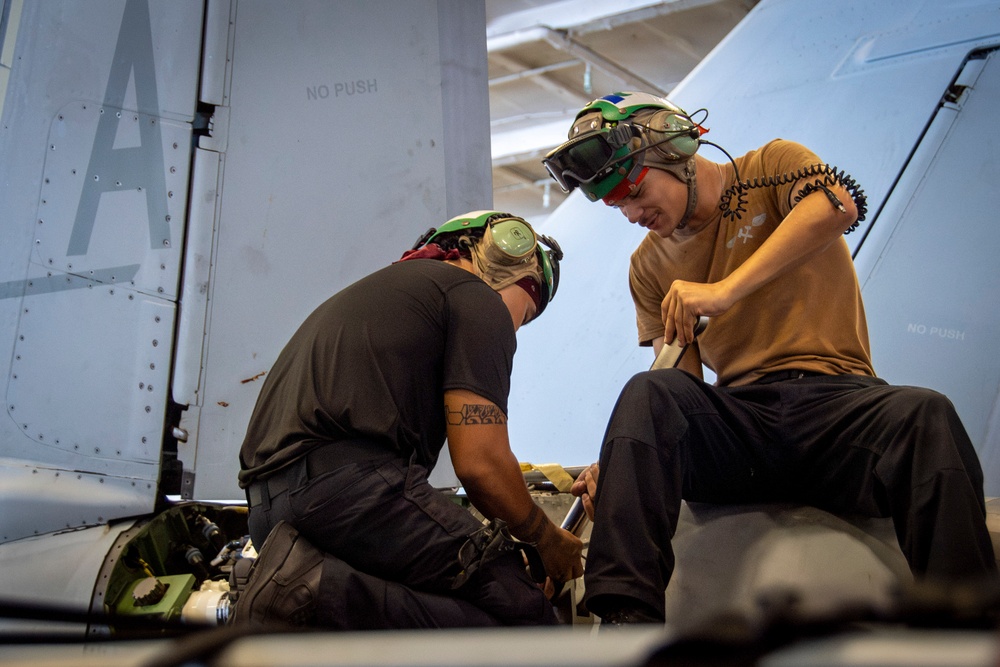 Nimitz Sailors Conduct Maintenance On Aircraft