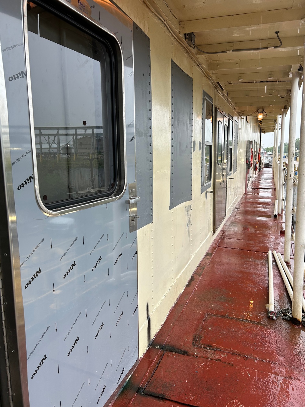 Dredge Potter maintenance to cover windows and replace galley door.