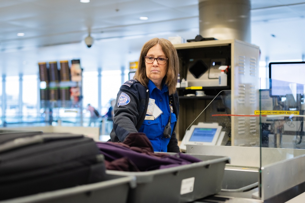 Officer performing the duties of a Transportation Security Officer on a TSA Checkpoint