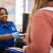 Officer screening passengers at a TSA checkpoint