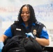 Officer screening passengers at a TSA checkpoint