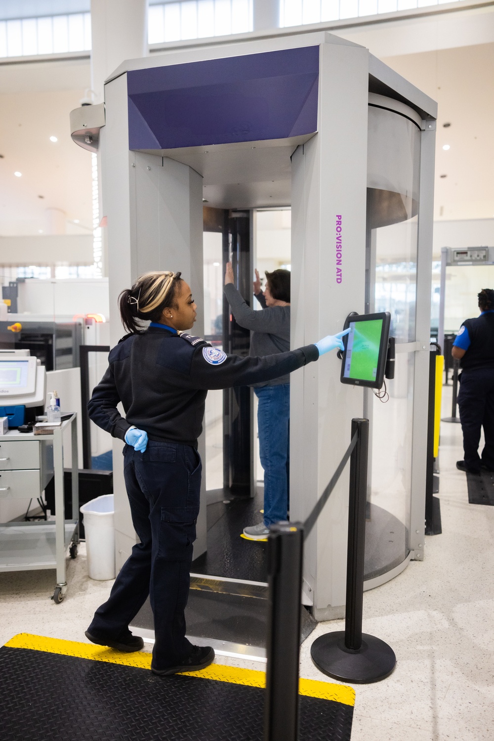 Officer screening passengers at a TSA checkpoint