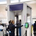 Officer screening passengers at a TSA checkpoint