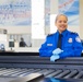 Officer screening passengers at a TSA checkpoint