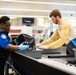 Officer screening passengers at a TSA checkpoint