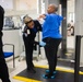 Officer screening passengers at a TSA checkpoint