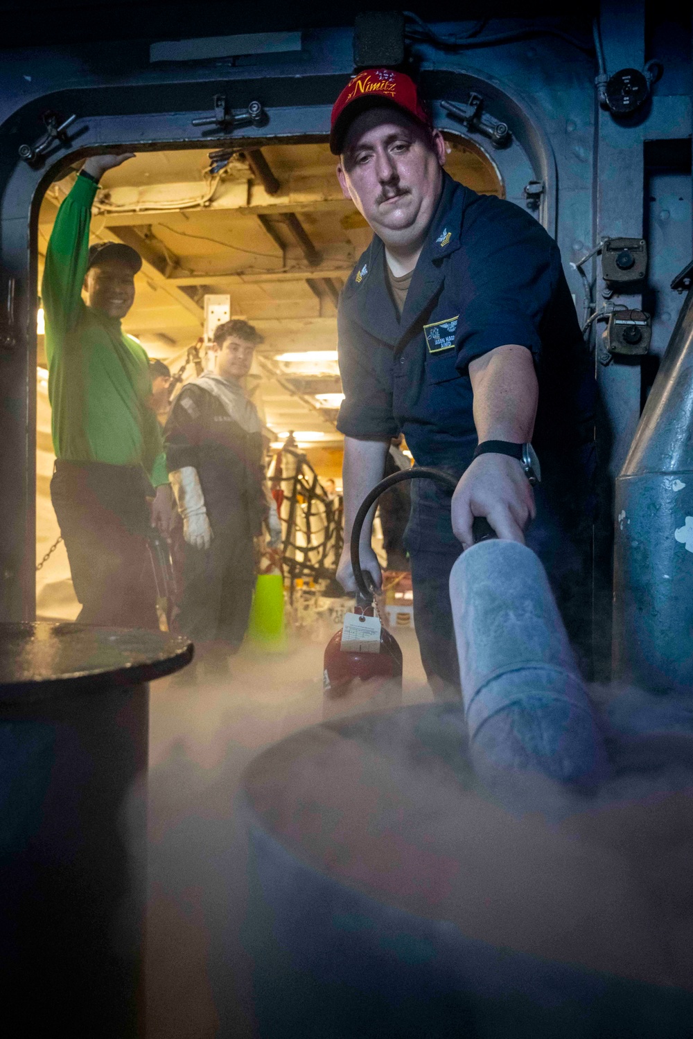 Nimitz Sailor Demonstrates A Fire Extinguisher Agent Test During General Quarters Drill
