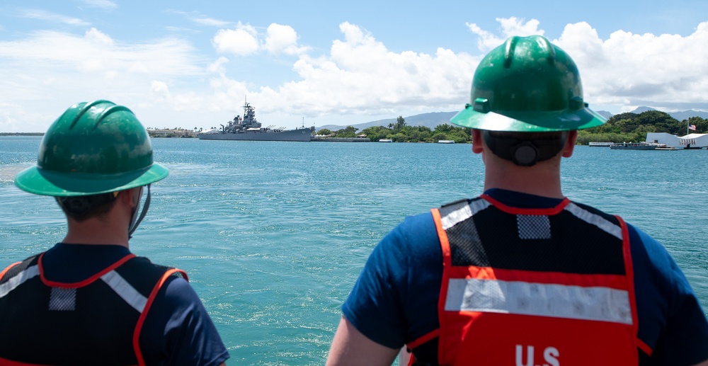 U.S. Coast Guard Cutter Stratton crew members prepare to depart Honolulu