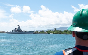 U.S. Coast Guard Cutter Stratton crew members prepare to depart Honolulu