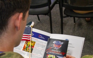 1LT Darrin Pollino reads an Honor Flight Syracuse brochure
