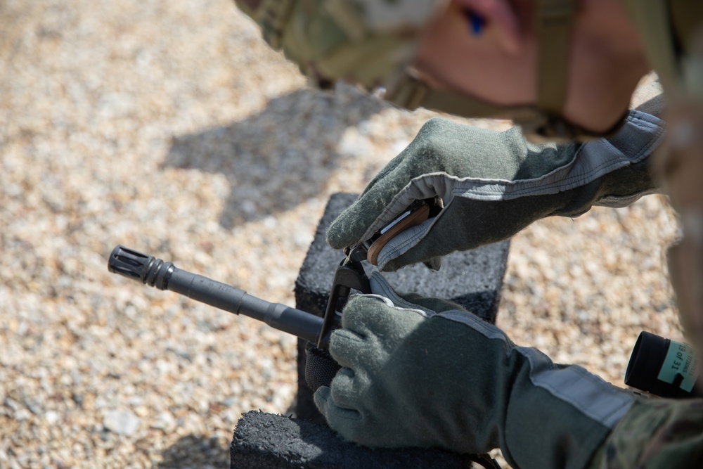 U.S. Army Sgt. William Fettig adjusts his front sight post