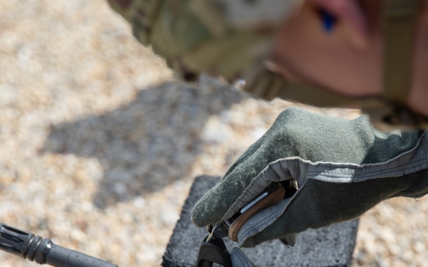 U.S. Army Sgt. William Fettig adjusts his front sight post