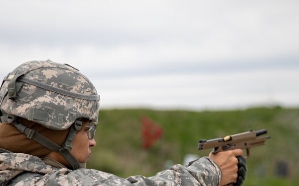 U.S. Army Maj. Jessica Modique fires her M17 pistol