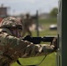 U.S. Army Sgt. Derek Combs, 350th Public Affairs Detachment, aims his M4