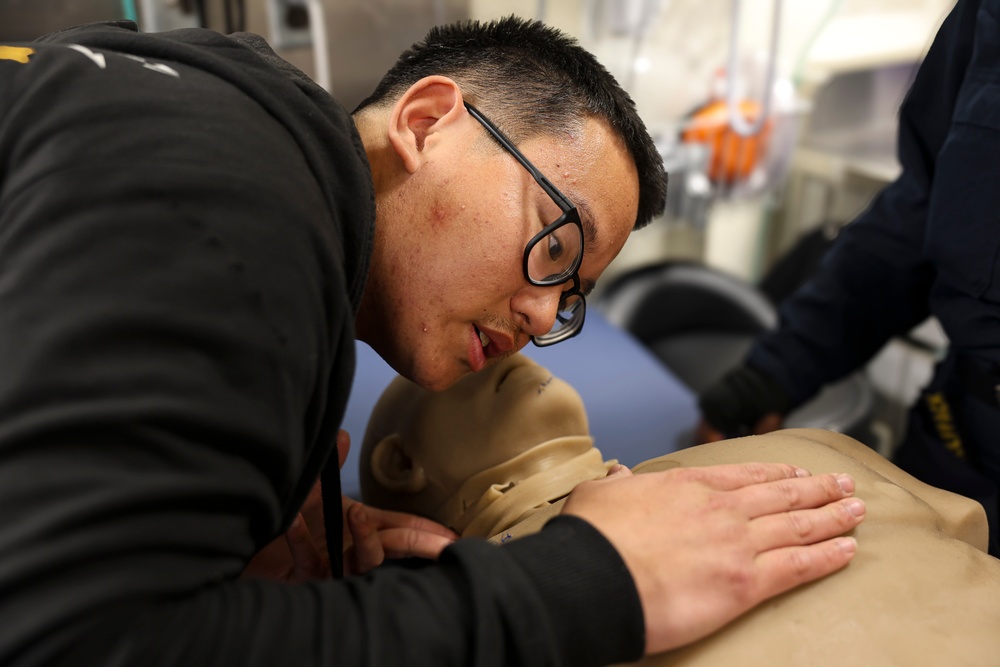 Hospital Corpsman 2nd Class Timothy Efendy demonstrates how to check cardiovascular and respiratory levels