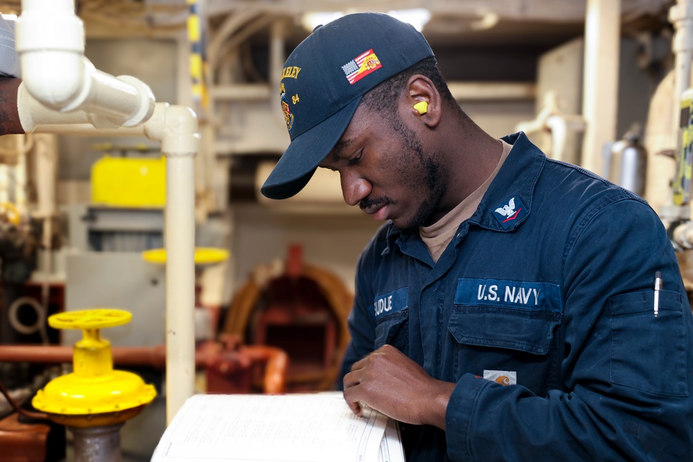 Gas Turbine Systems Technician (Mechanical) 3rd Class Gregory Sudue reviews maintenance procedures