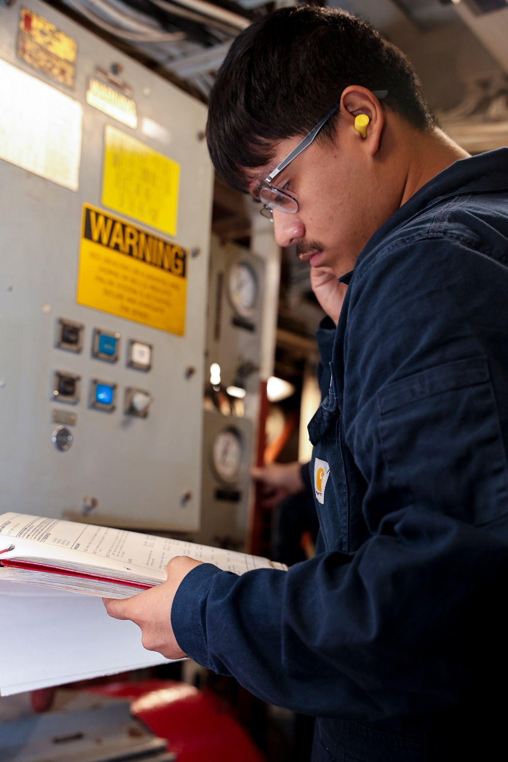 Gas Turbine Systems Technician (Mechanical) Fireman Daniel  Martinez reviews maintenance procedures