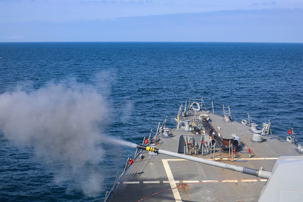 The Arleigh Burke-class guided-missile destroyer USS Bulkeley (DDG 84), fires a Mark 45 5-inch light-weight gun
