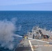 The Arleigh Burke-class guided-missile destroyer USS Bulkeley (DDG 84), fires a Mark 45 5-inch light-weight gun