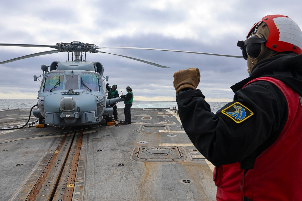 Aviation Ordnanceman 2nd Class Jarrett Parker signals to ground crew