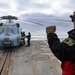 Aviation Ordnanceman 2nd Class Jarrett Parker signals to ground crew