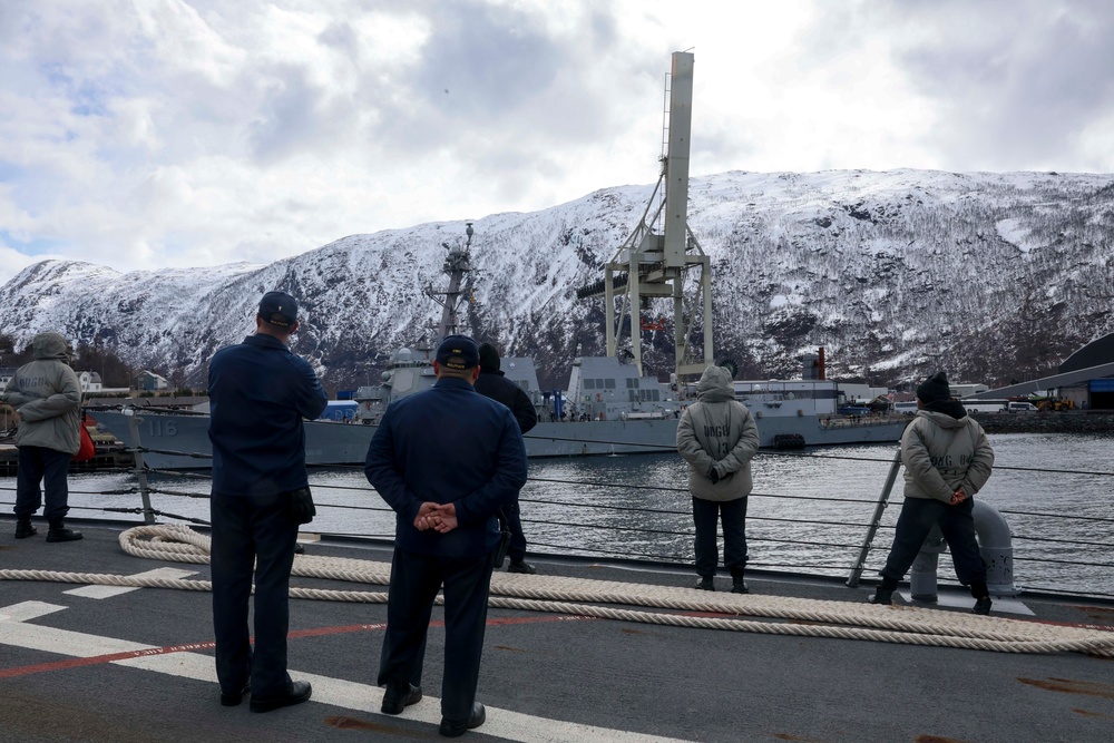 U.S. Navy Sailors man the rails while pulling into the port of Narvik, Norway.