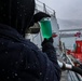 Gas Turbine Systems Technician 2nd Class Robert Capps inspects fuel for contaminants during a replenishment