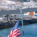 U.S. Navy Sailor brings down the ensign during a sea-and-anchor detail