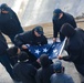 U.S. Navy Sailors fold the ensign during a sea-and-anchor detail