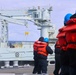 U.S. Navy Sailors heave in the phone and distance line from the Royal Canadian Navy replenishment oiler MV Asterix