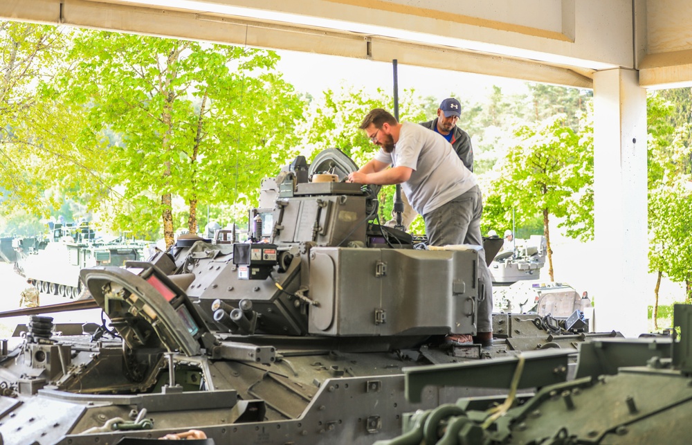 3rd Infantry Division Soldiers and Department of Defense civilian contractors install MILES gear on M2A4 Bradleys during Combined Resolve 25-02