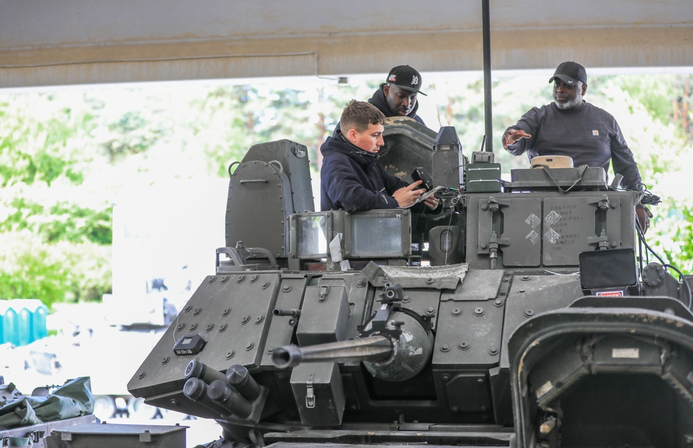 3rd Infantry Division Soldiers and Department of Defense civilian contractors install MILES gear on M2A4 Bradleys during Combined Resolve 25-02