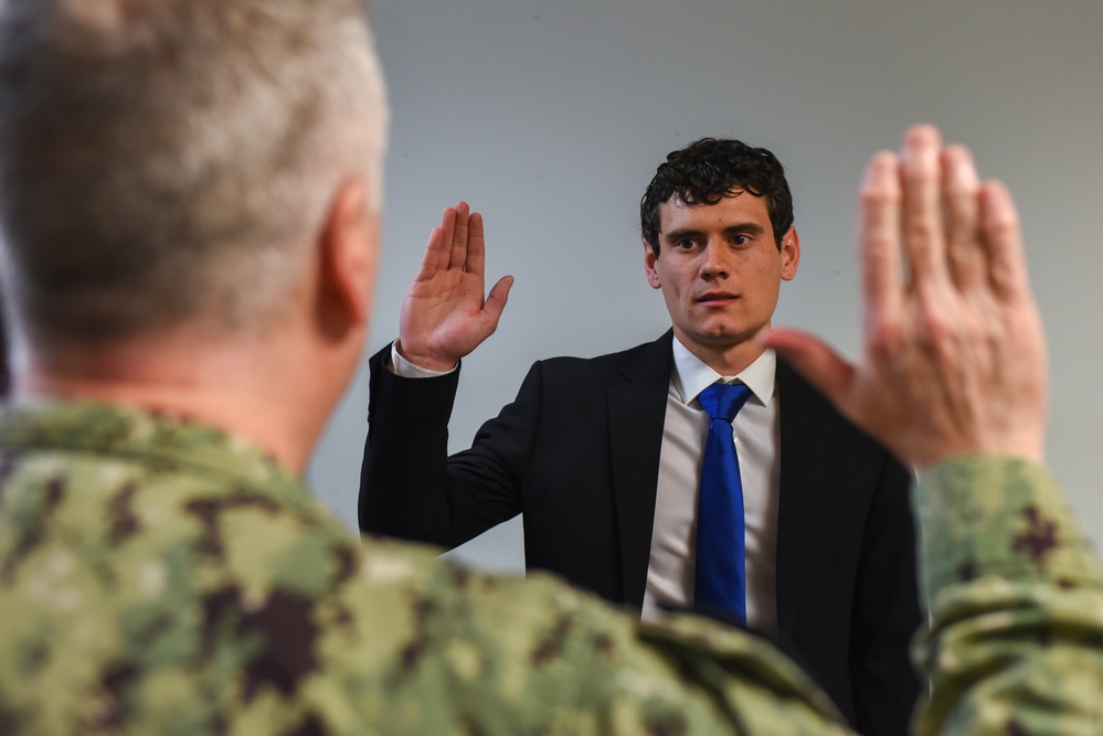 Rear Adm. James Waters, Commander, Navy Recruiting Command, left, conducts the Oath of Enlistment for future Sailor Edward Orcutt at Navy Talent Acquisition Group Ohio River Valley.