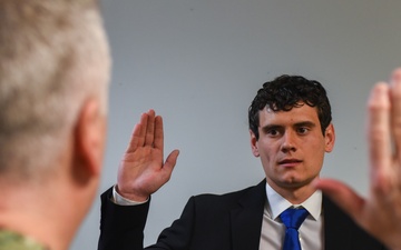 Rear Adm. James Waters, Commander, Navy Recruiting Command, left, conducts the Oath of Enlistment for future Sailor Edward Orcutt at Navy Talent Acquisition Group Ohio River Valley.