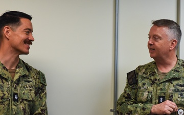 Rear Adm. James Waters, Commander, Navy Recruiting Command, right, speaks with Cmdr. Patrick Henken, commanding officer, Navy Talent Acquisition Group Ohio River Valley.