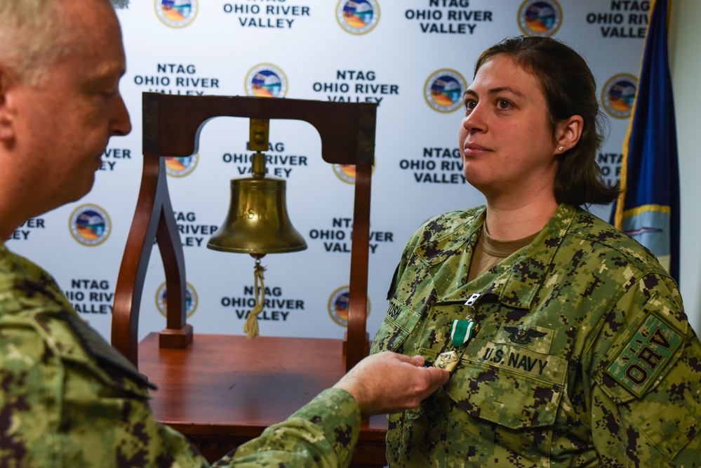 Rear Adm. James Waters, Commander, Navy Recruiting Command, presented Navy Counselor 1st Class Katharina Tosh with a Navy Commendation Medal
