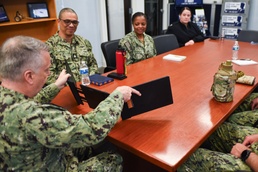 Rear Adm. James Waters, Commander, Navy Recruiting Command, shows officer recruiters, assigned to Navy Talent Acquisition Group Ohio River Valley, a new trifold monitor configuration for government-issued laptops