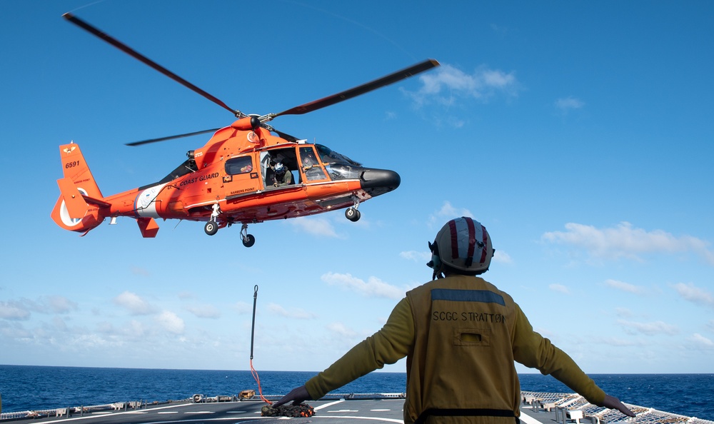 U.S. Coast Guard Cutter Stratton crew train with an U.S. Coast Guard Air Station Barbers Point MH-65 Dolphin aircrew near Hawaii
