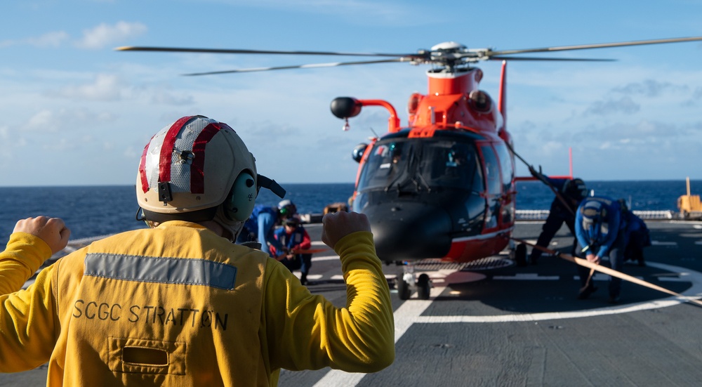U.S. Coast Guard Cutter Stratton crew train with an U.S. Coast Guard Air Station Barbers Point MH-65 Dolphin aircrew near Hawaii