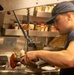 U.S. Coast Guard Cutter Stratton culinary specialists prepare lunch while transiting on the Pacific Ocean