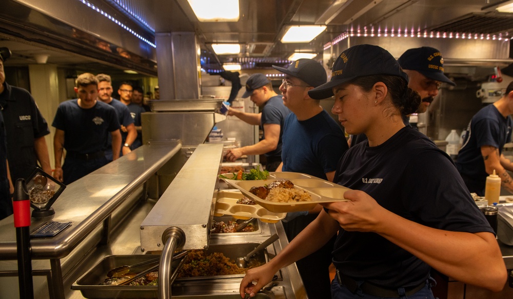 U.S. Coast Guard Cutter Stratton culinary specialists prepare lunch while transiting on the Pacific Ocean