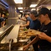 U.S. Coast Guard Cutter Stratton culinary specialists prepare lunch while transiting on the Pacific Ocean
